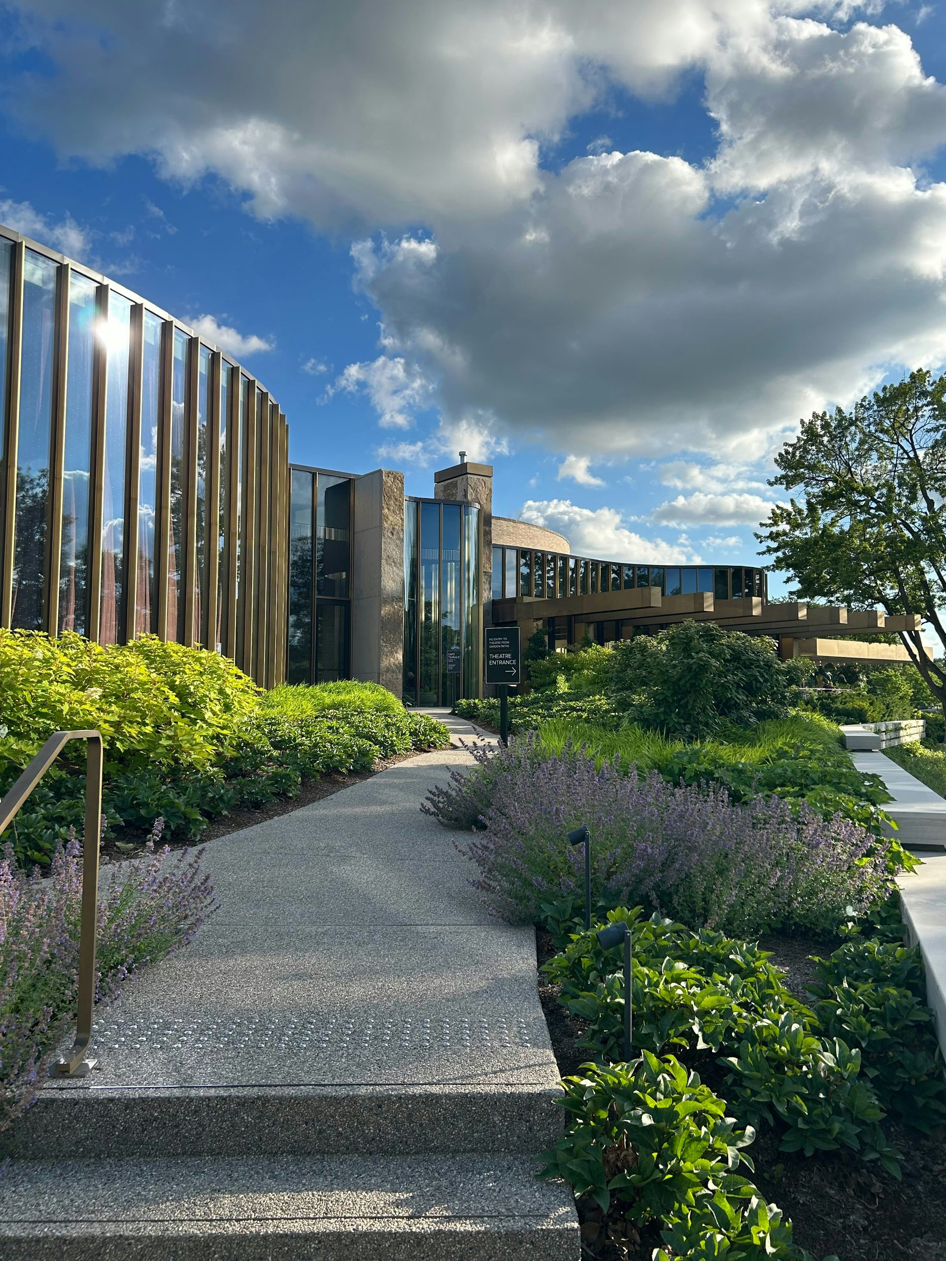 Modern building with curved architecture and lush green landscaping